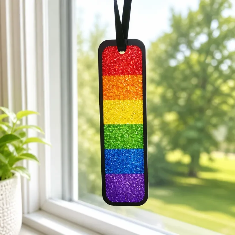 Colorful Rainbow Crayon Suncatcher craft hanging in a window for kids' decoration